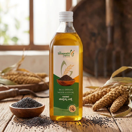 Bottle of Saraswath Organics bull driven niger seedoil with niger seeds on a wooden surface
