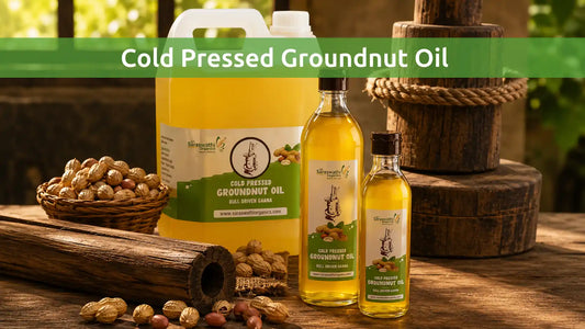 Sri Saraswathi Organics cold pressed groundnut oil in bottles and bulk container with peanuts and traditional wooden oil press
